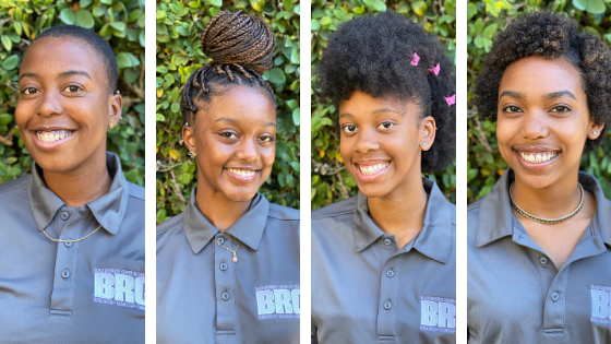 Photo of four Black Resource Center Student Success Leaders. All four of these interns are Black women (pronouns are she/her) and they are wearing grey polos with a white BRC logo on the right upper chest.